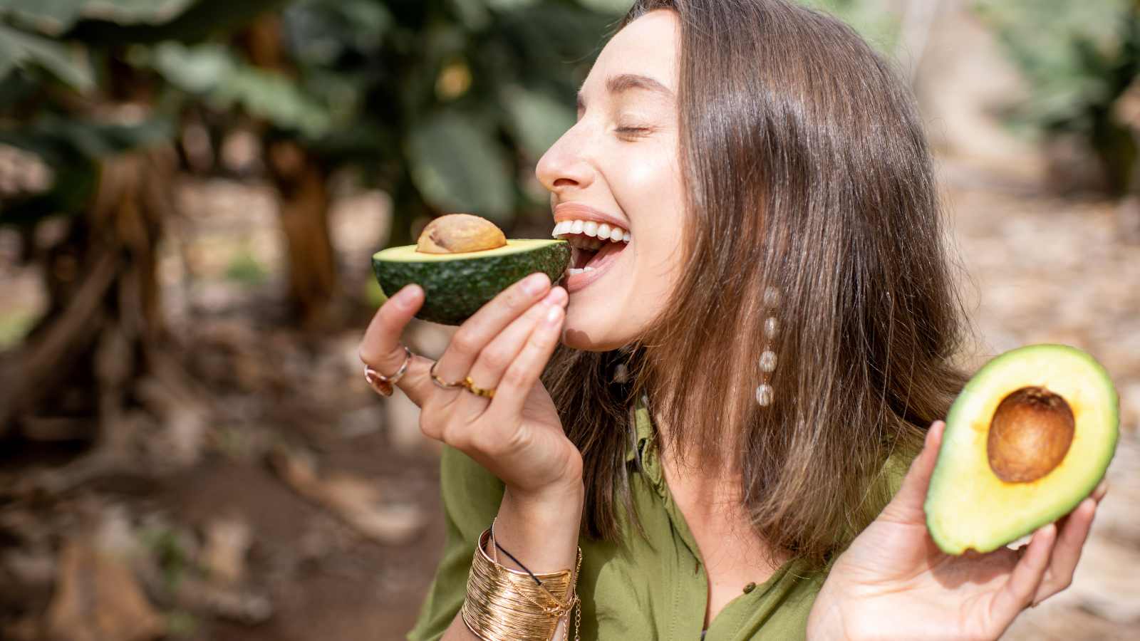 woman eating avocado