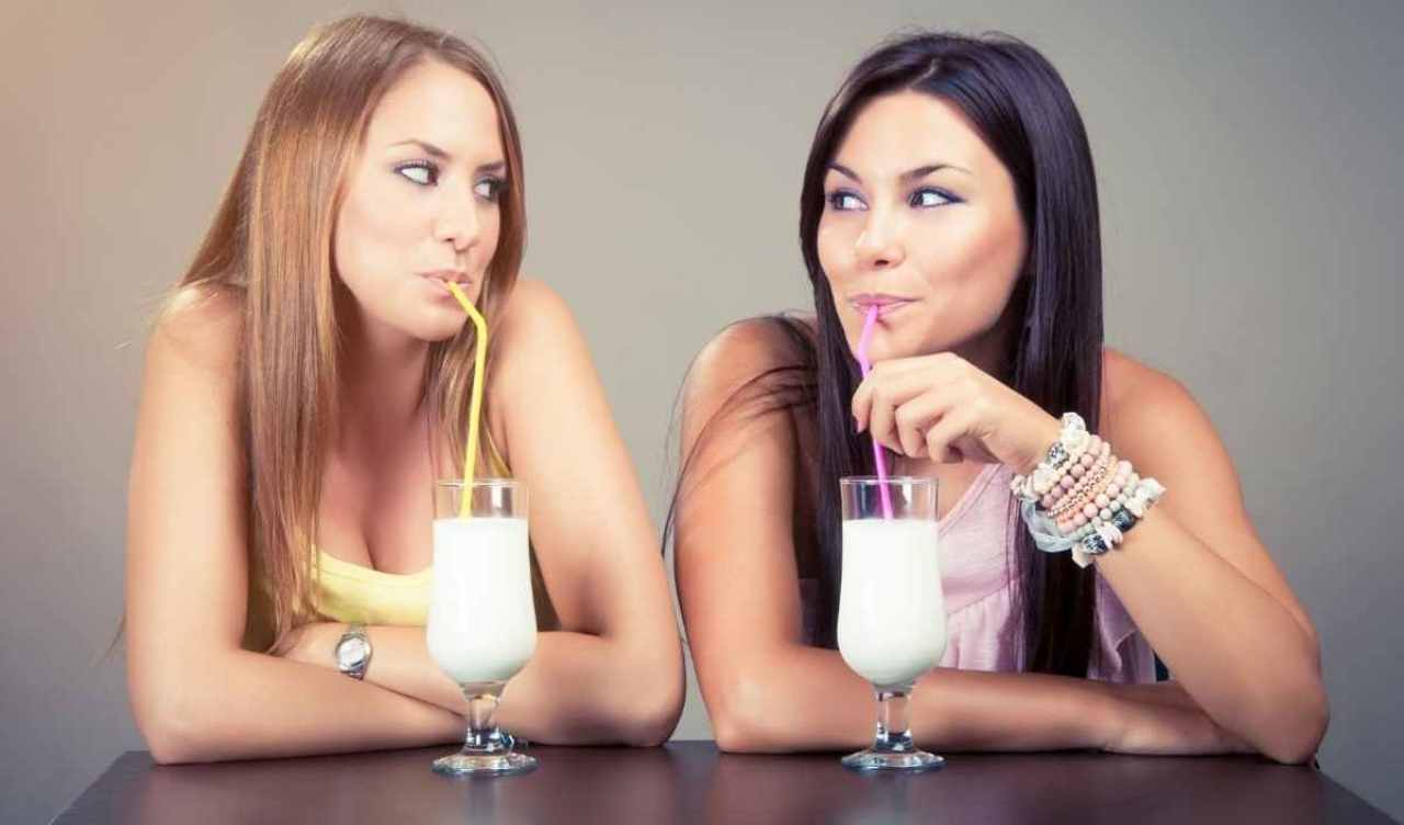two ladies drinking milk