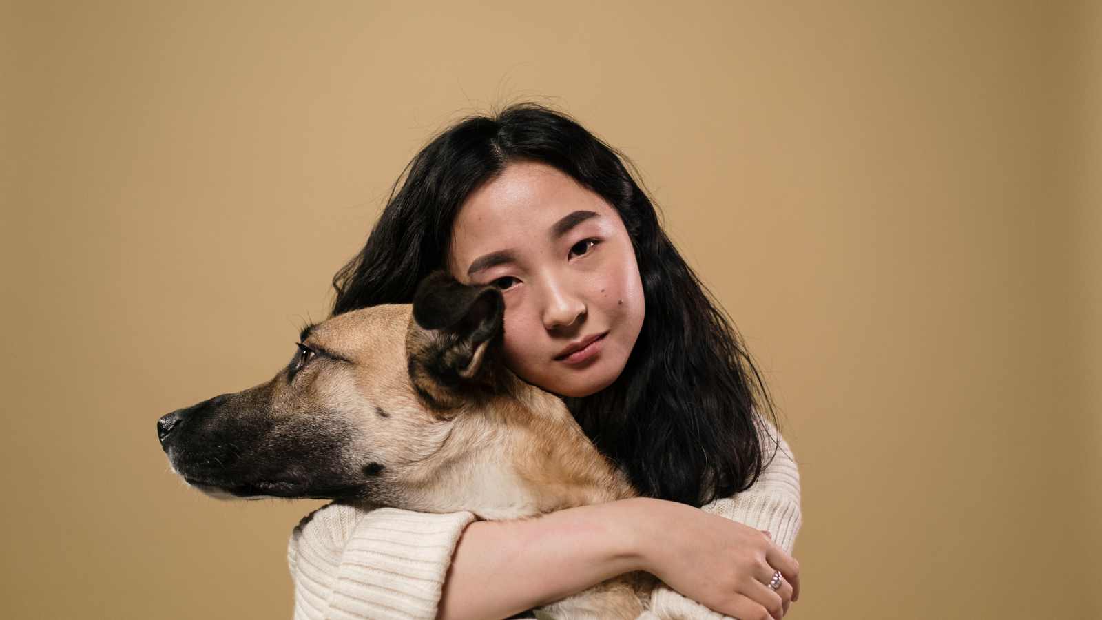owner hugging pet dog