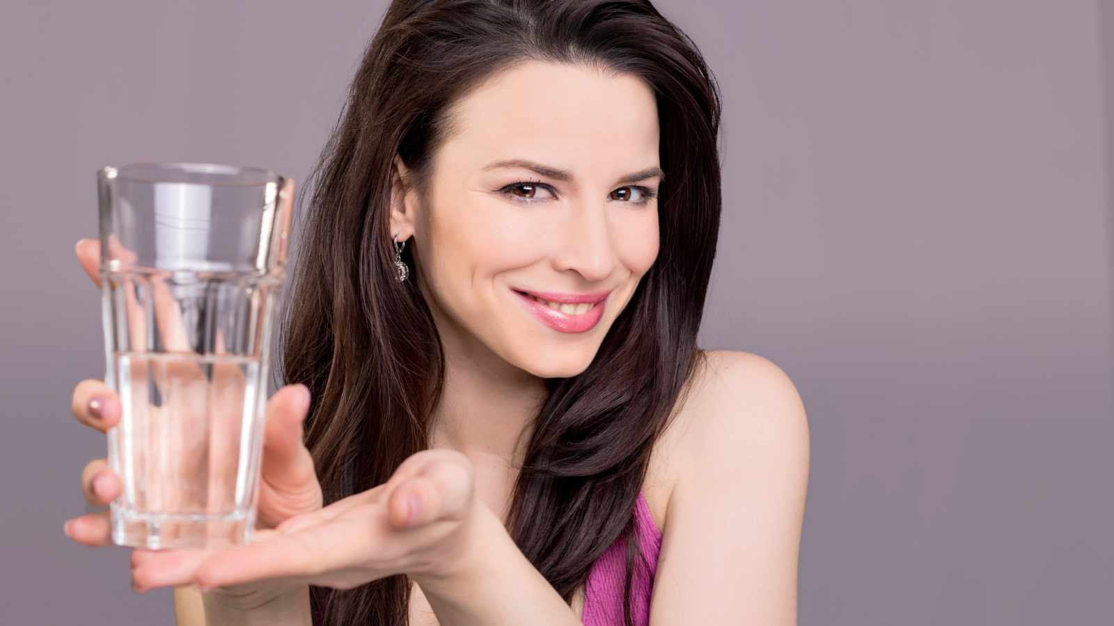 Woman holding up a glass of water