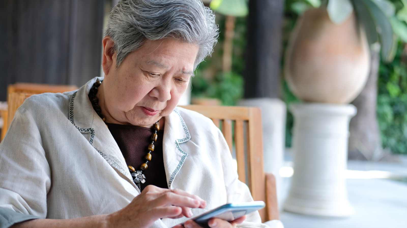 elderly asian woman using smartphone