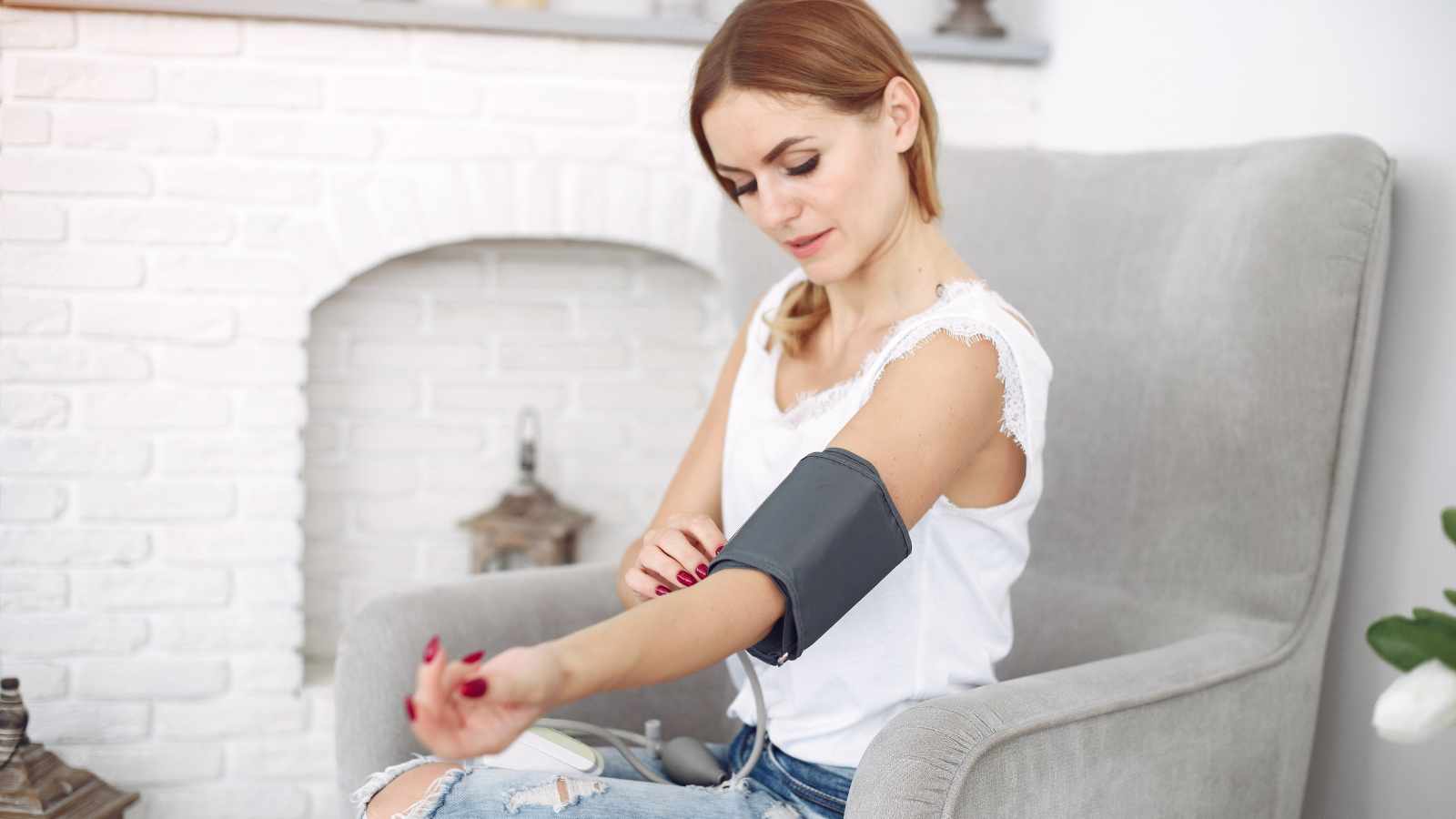 Lady checking blood pressure at home