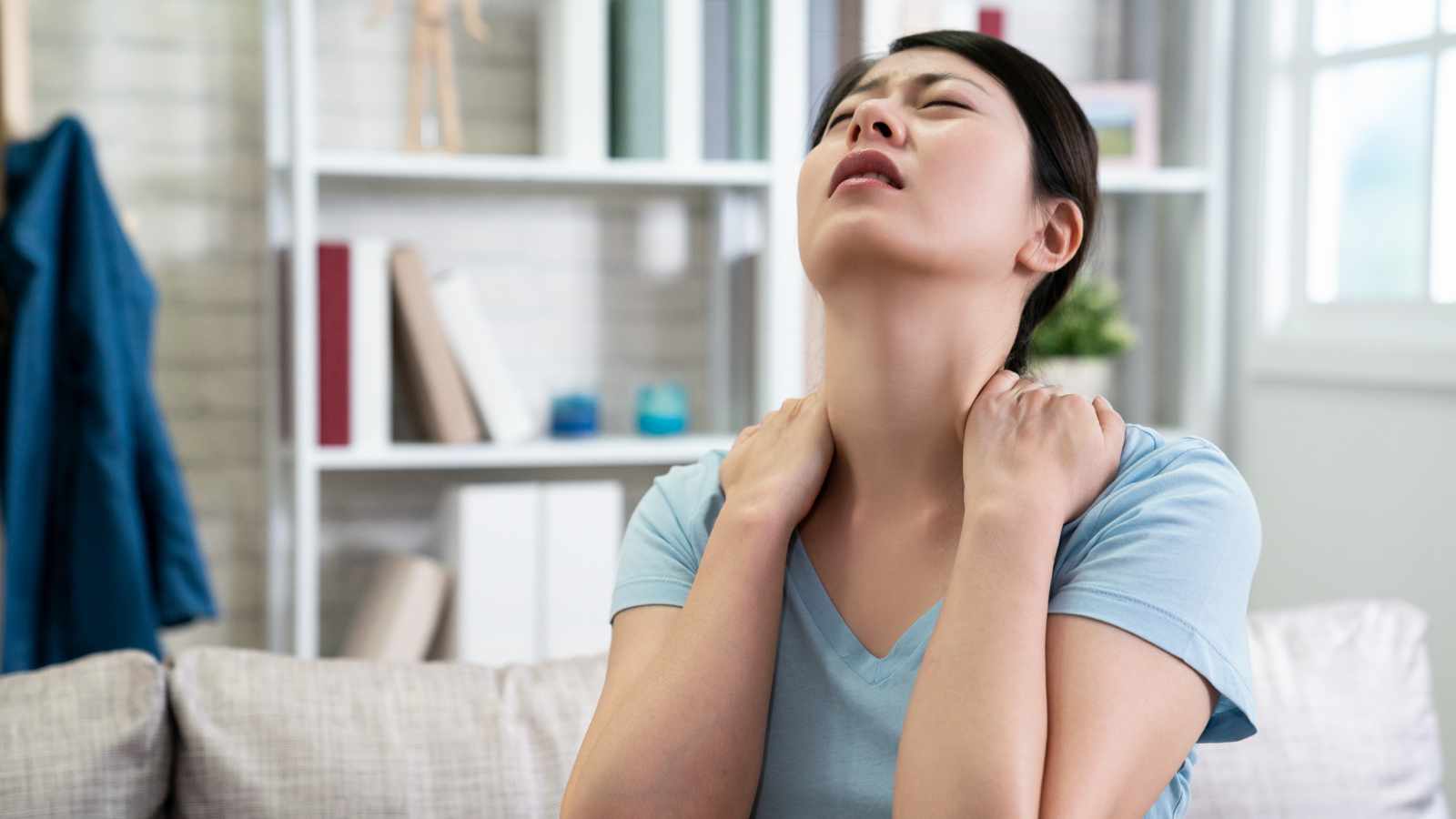 Lady feeling neck pain