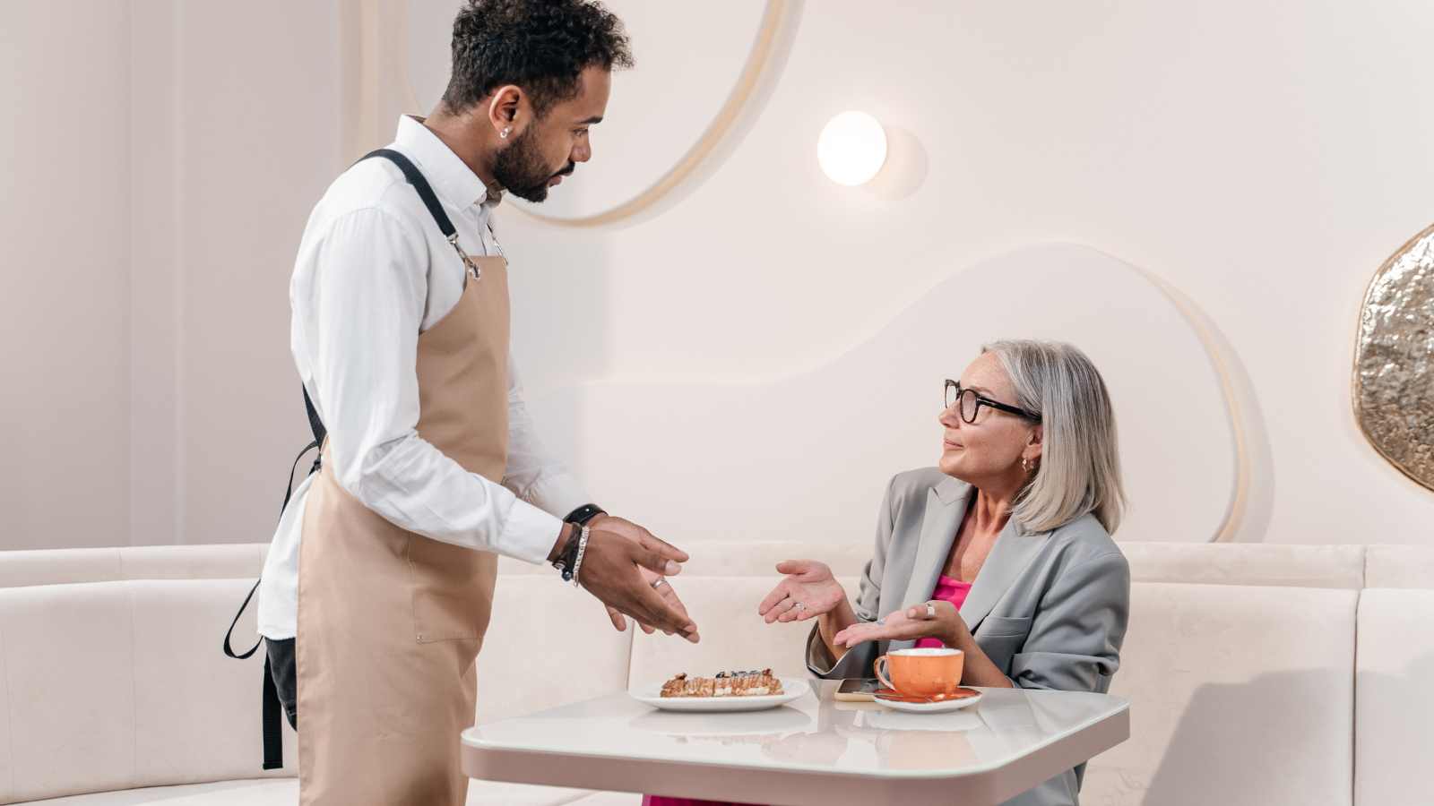 lady talking to waiter in a restaurant