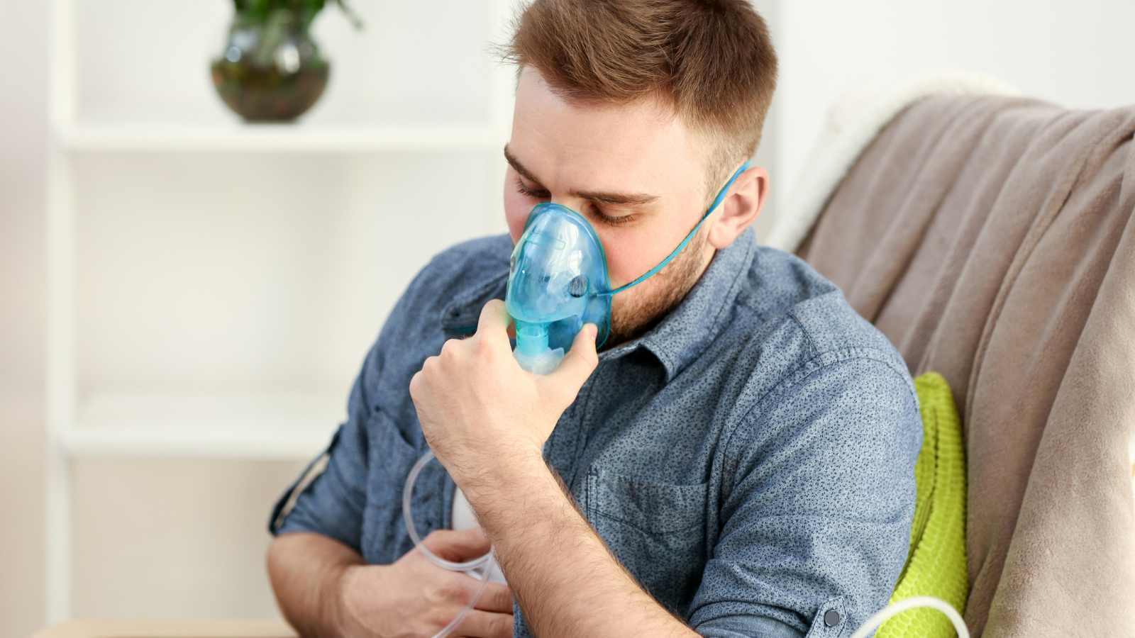 man breathing through a Nebulizer