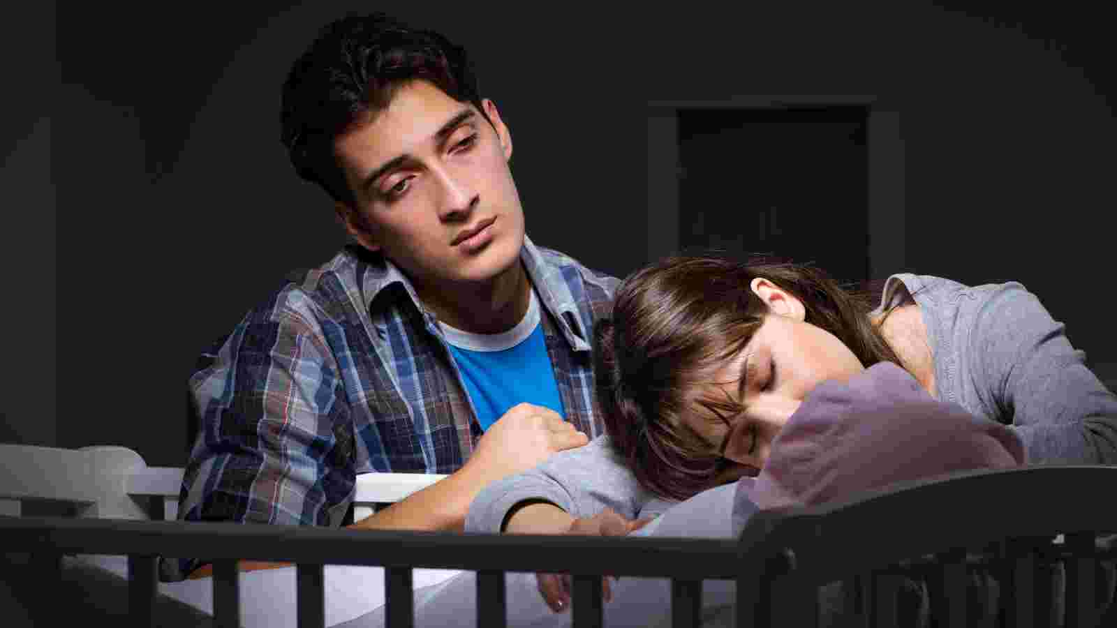 Couple with baby in crib