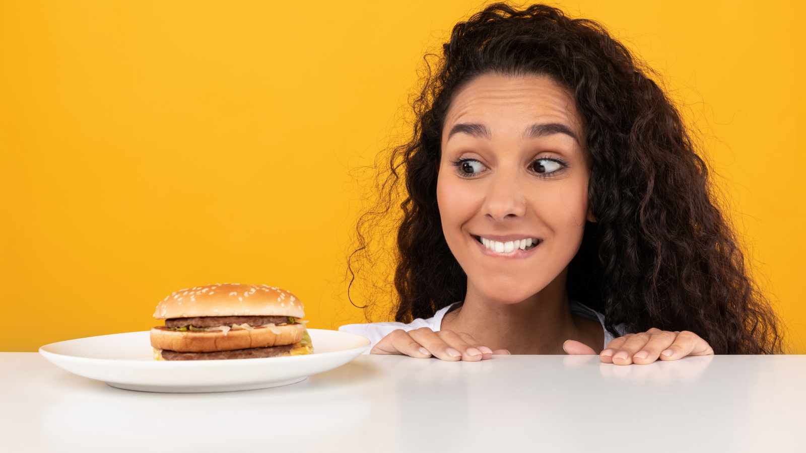 Lady peeping at a burger