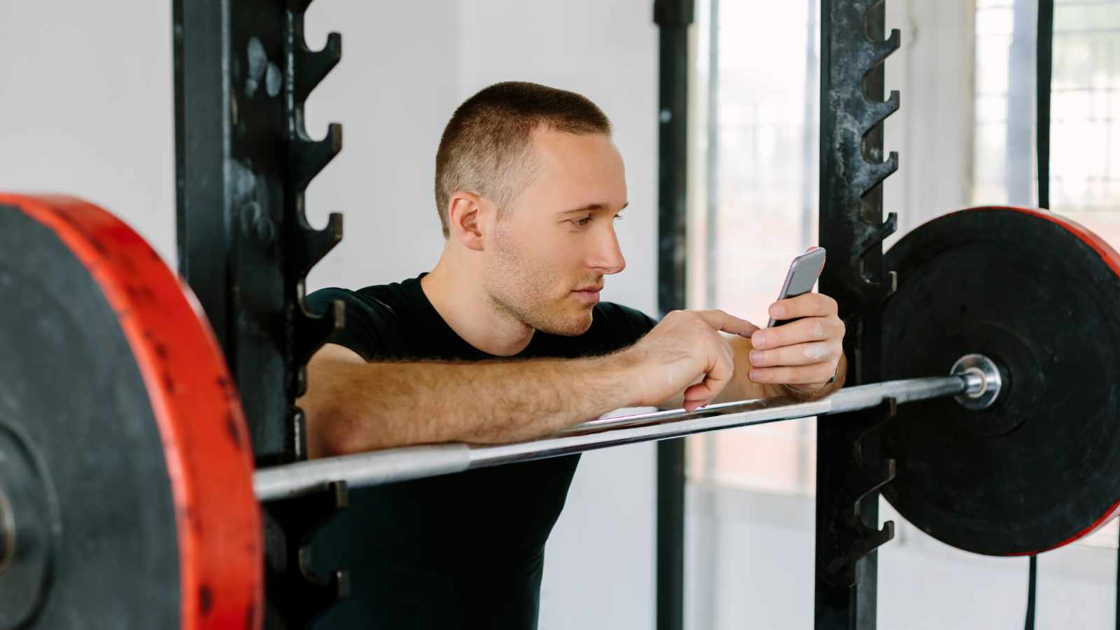 Man texting at the gym