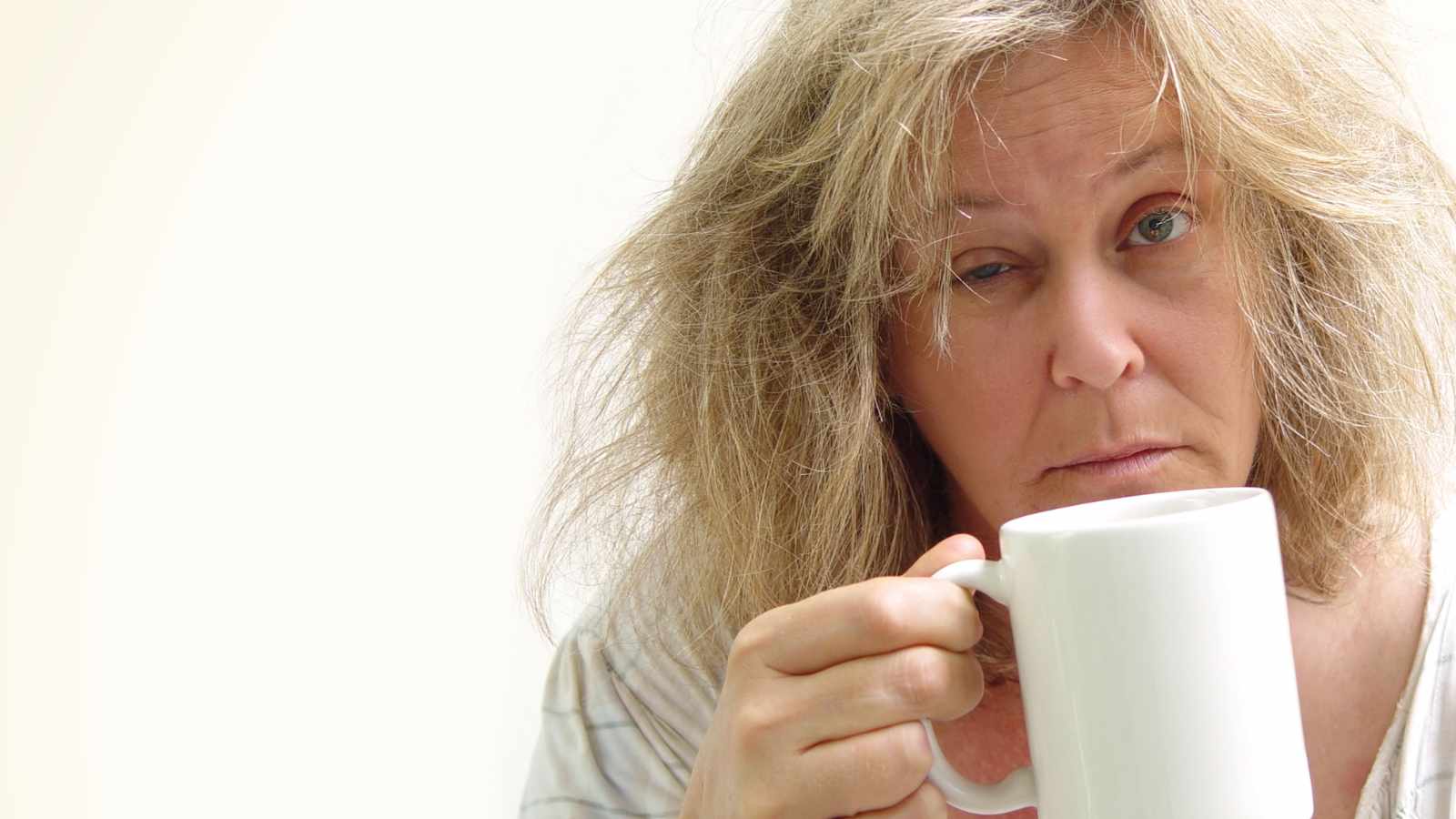 Tired lady with a cup of coffee