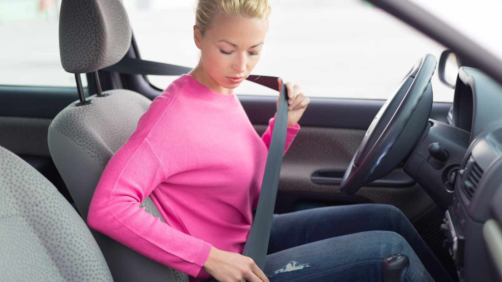 Lady fixing a seat belt