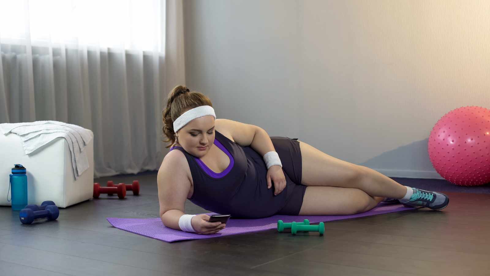 Lazy lady laying on gym mat