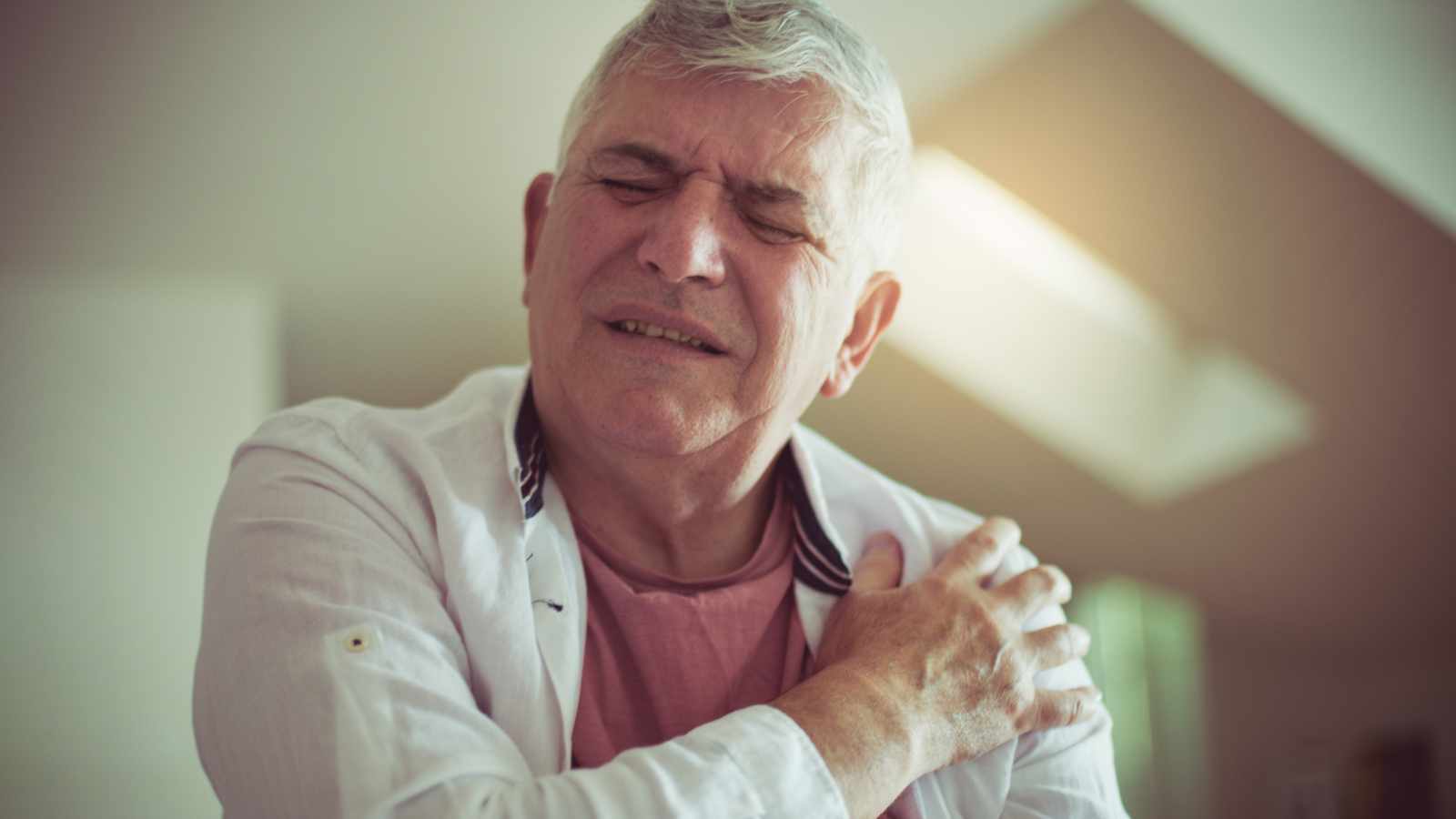 Man feeling pain in shoulder