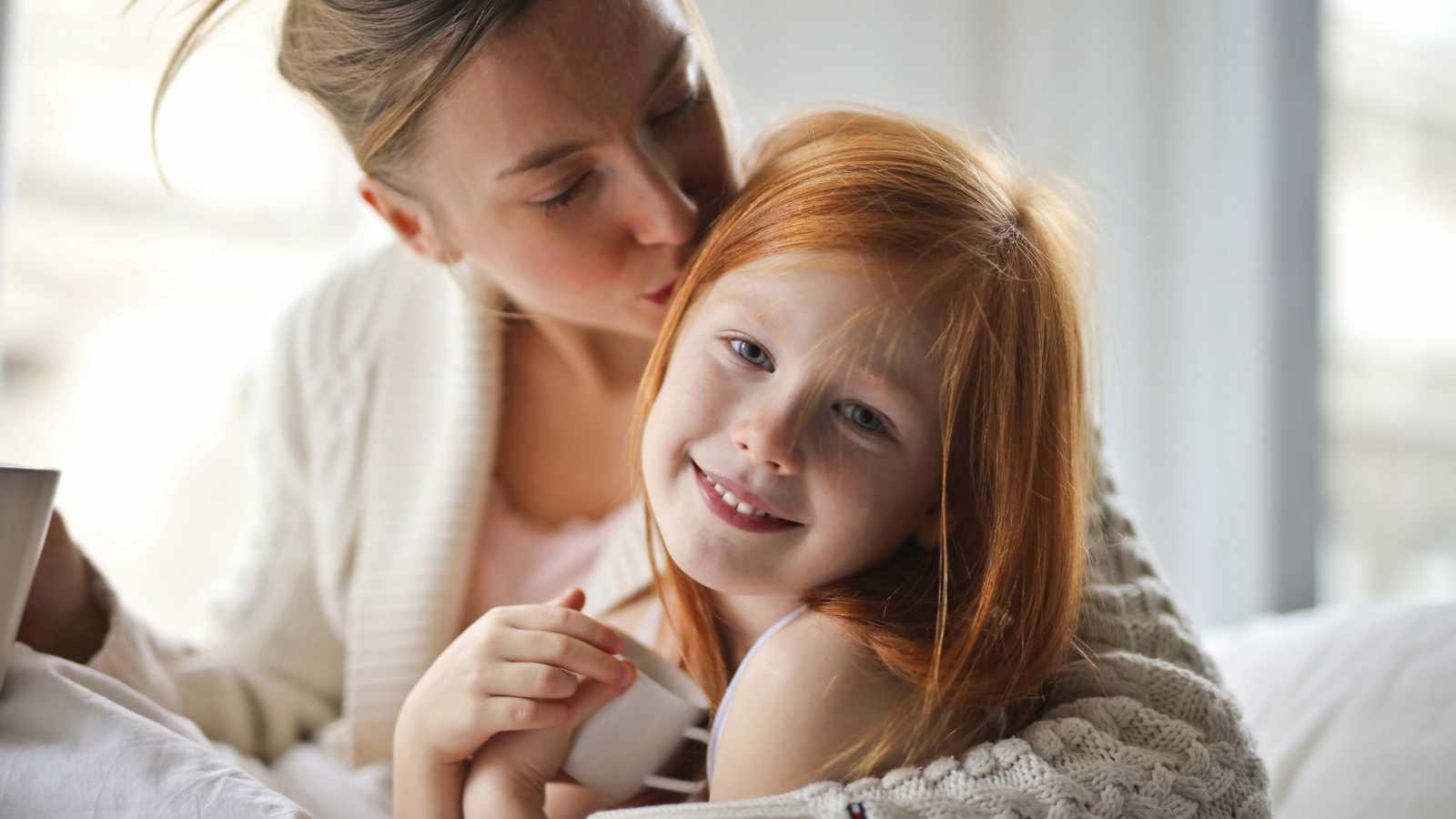 Mother kissing her child