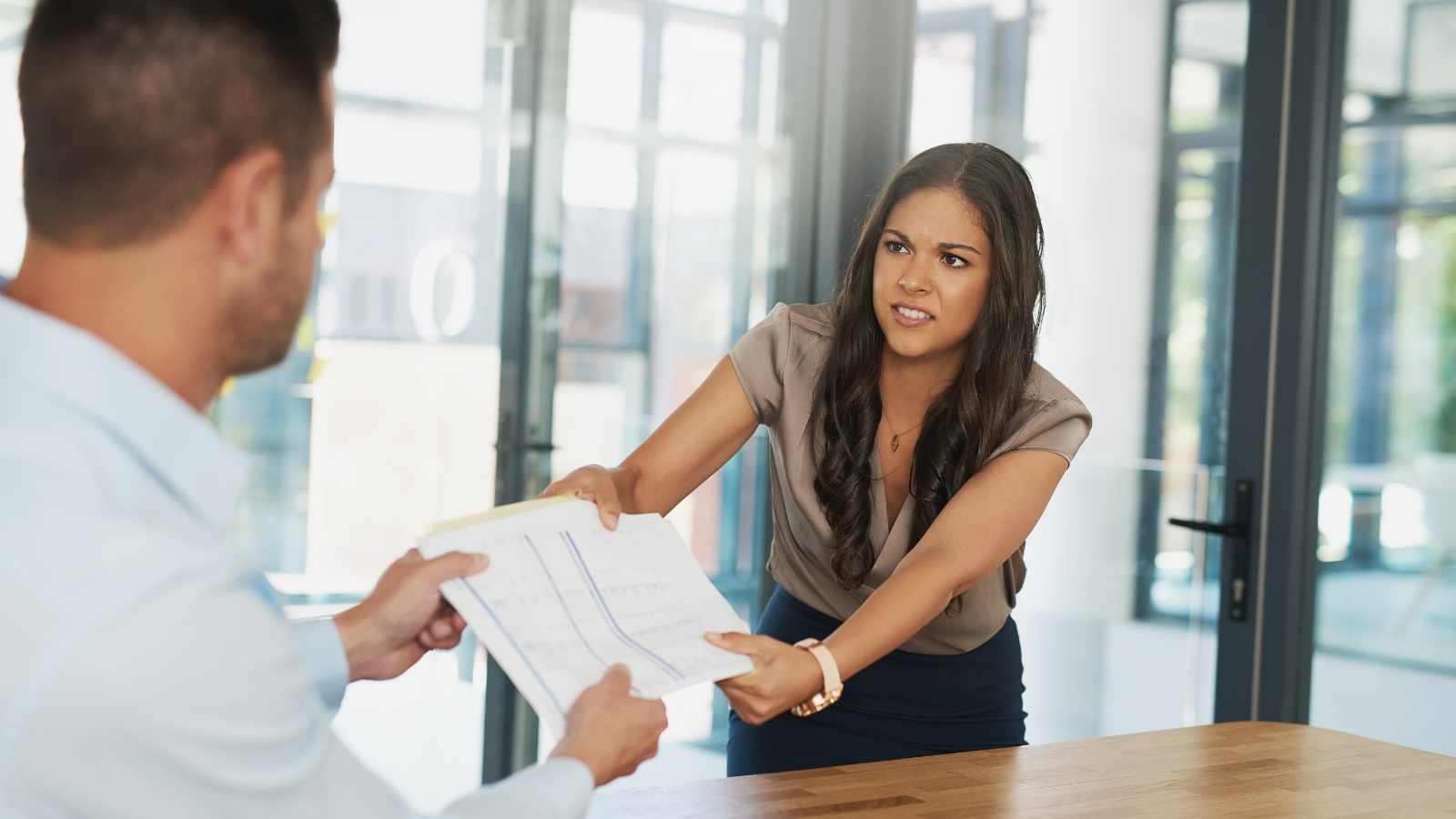 Lady pulling documents from colleague