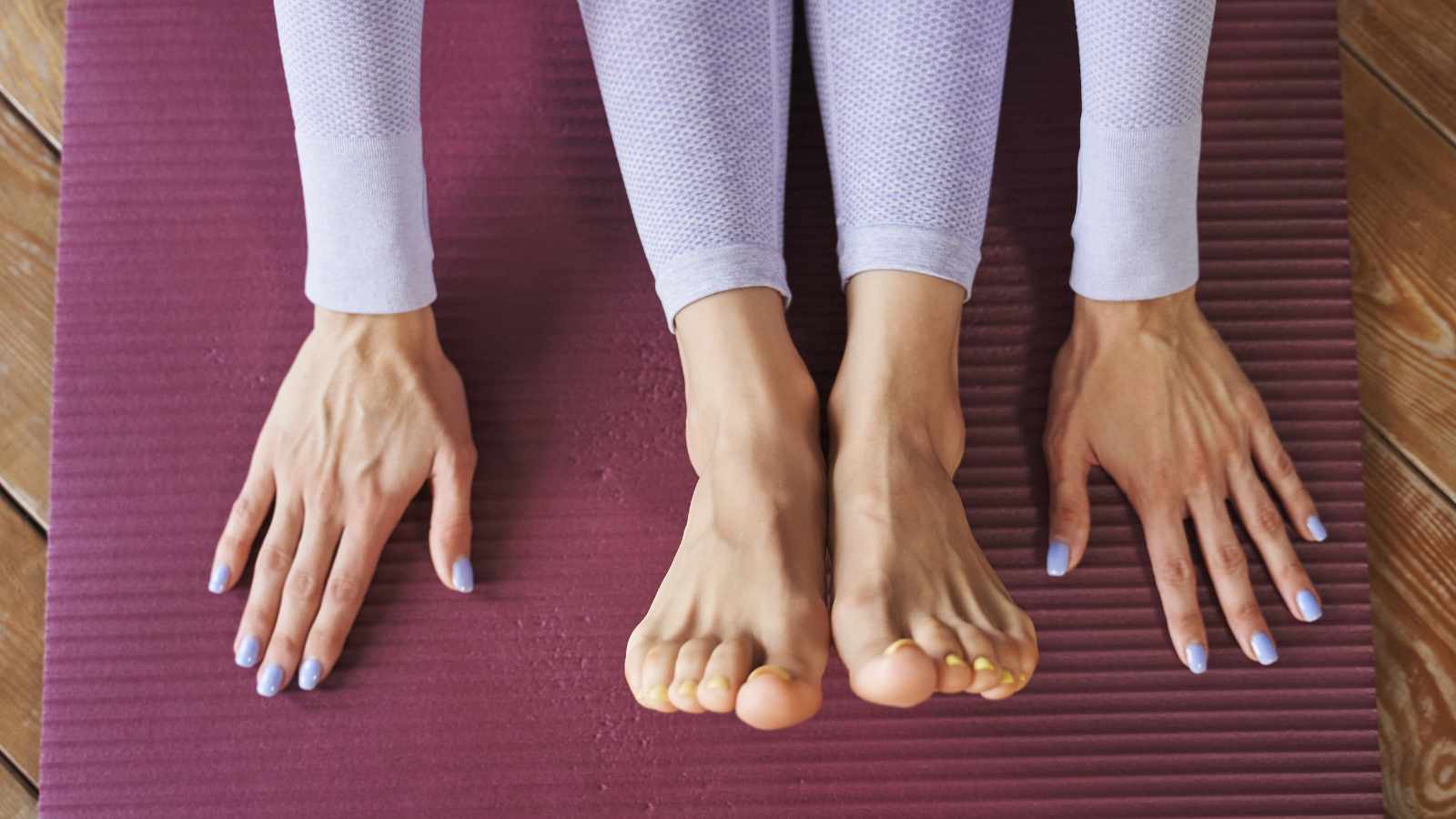 female palms and feet on yoga mat
