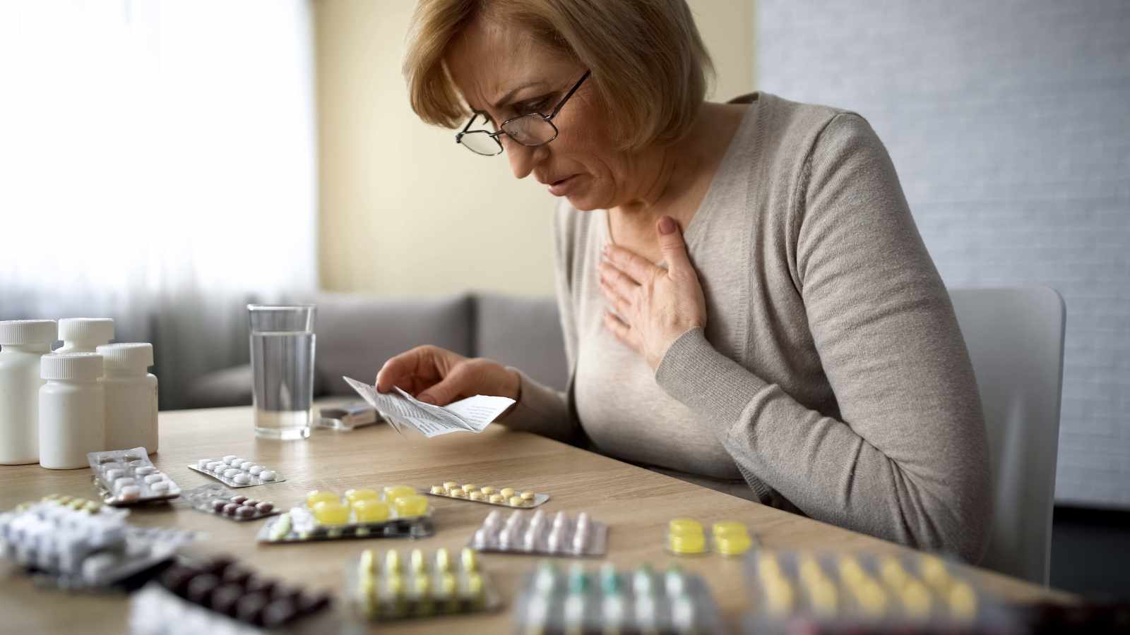 Senior lady trying to self medicate during a heart attack