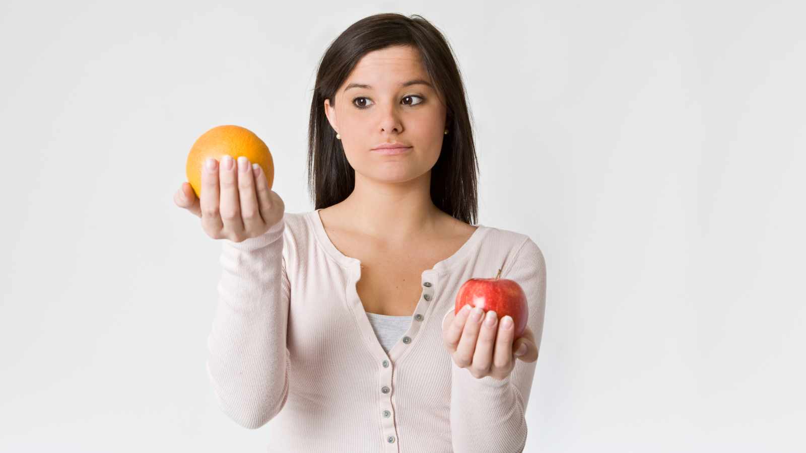 Lady comparing apple and orange