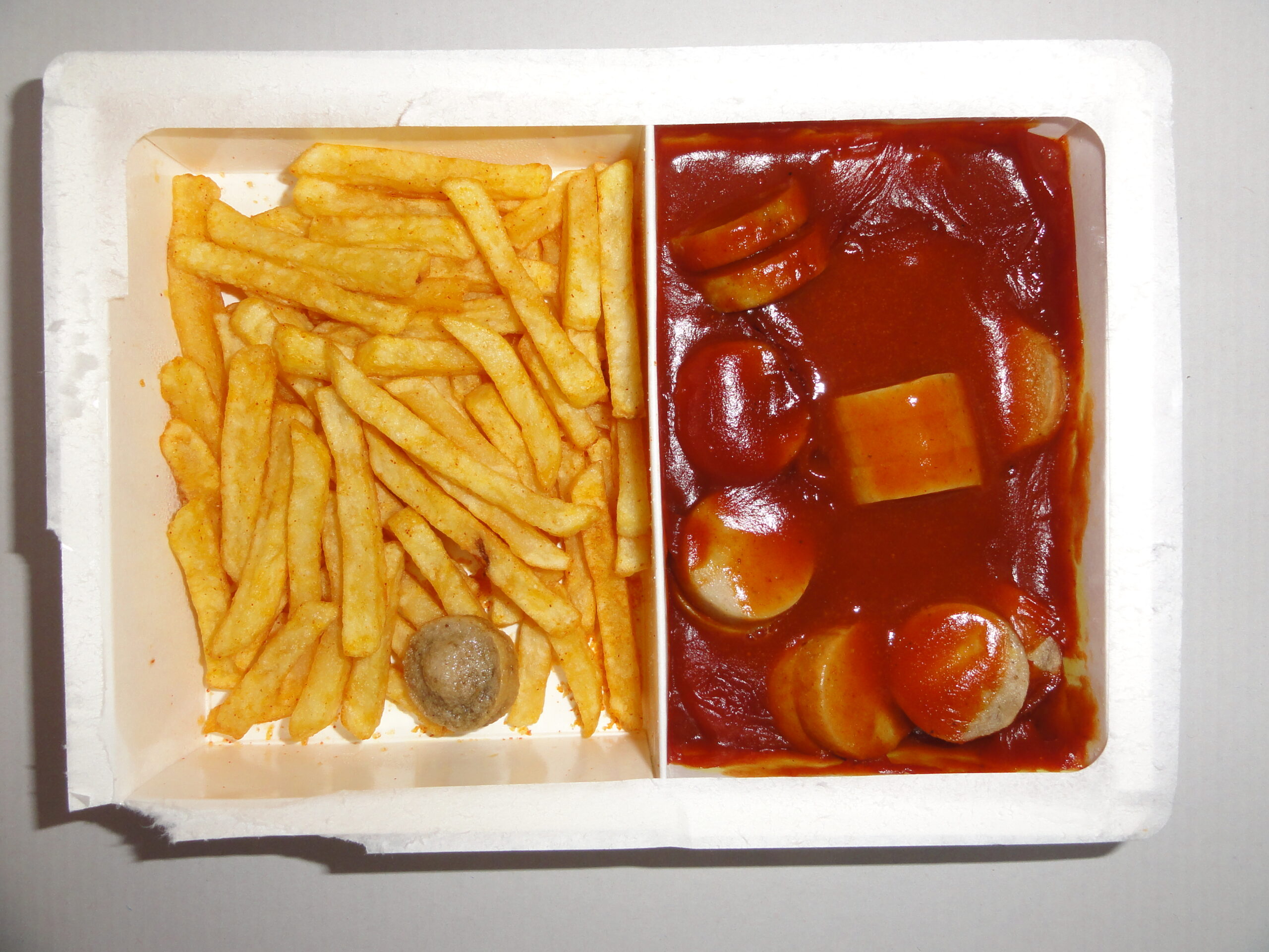 Ready to eat microwave food TV dinner Currywurst with French fries scaled